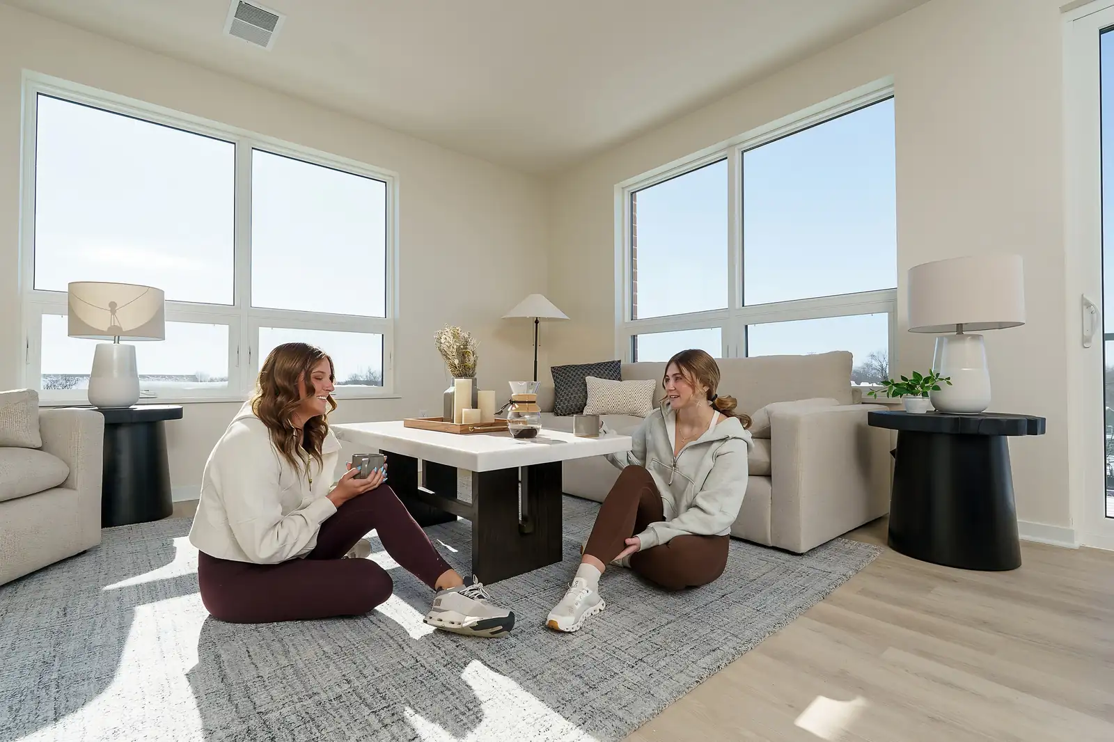 Two residents relaxing in a furnished apartment